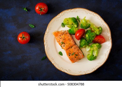 Baked Salmon Garnished With Broccoli And Tomato. Top View