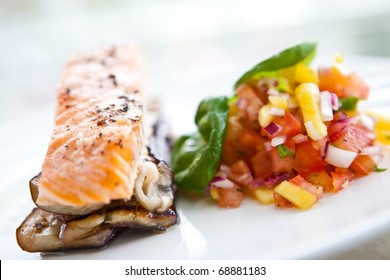 Baked Salmon On Bed Of Grill Aubergine With Serving Of Mango And Tomato Salsa