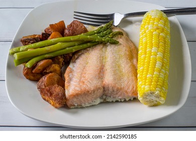 Baked Salmon Served With Corn , Asparagus  And Red Roasted Potatoes