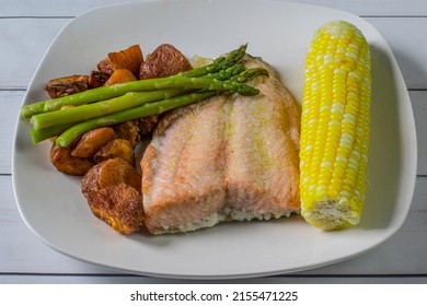 Baked Salmon Served With Corn , Asparagus  And Red Roasted Potatoes