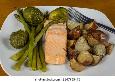 Baked  Salmon Served With Red Roasted Potatoes And Asparagus