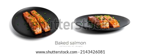 Baked salmon in soy sauce with herbs on black plate isolated on a white background. High quality photo