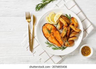 Baked Salmon Steak And Roasted Potatoes On A White Plate, Horizontal View From Above, Flat Lay, Free Space