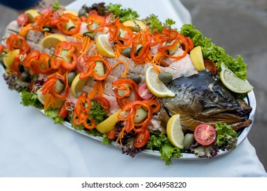 Baked Salmon With Vegetables And Lemon On A Platter. Delicious Fish Dish With Vegetables And Unusual Presentation. Whole Salmon Baked With Tomatoes, Cucumbers And Lemon