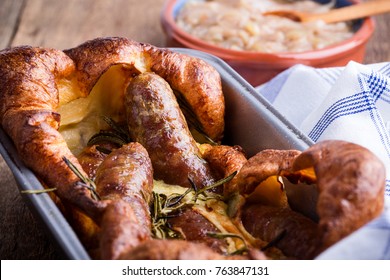 Baked Sausages In Yorkshire Pudding Batter And Served With  Onion Gravy, Toad In The Hole  