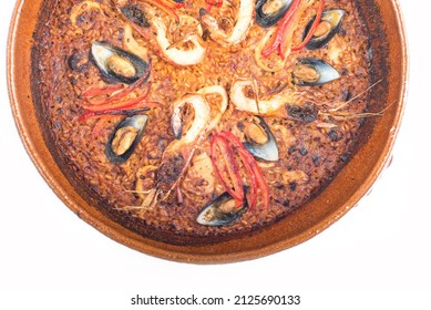 Baked Seafood With Vegetables In A Clay Plate. Mussels And Shrimps. Top View On A White Background. Close-up.