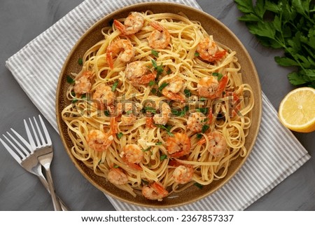 Baked Shrimp Scampi Linguine Pasta with Parsley on a Plate, top view. Flat lay, overhead, from above.