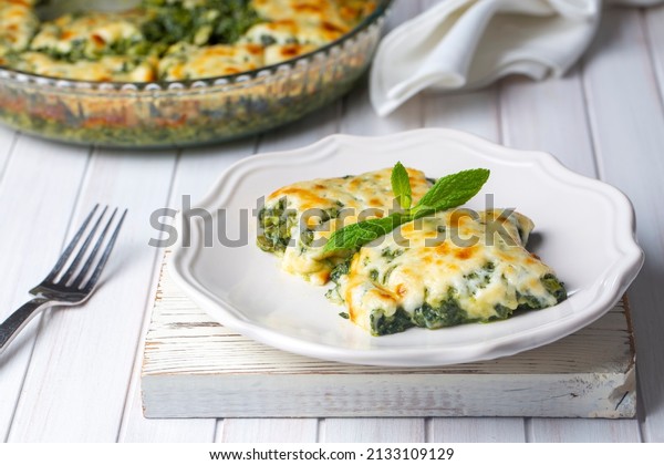 Baked Spinach with cheese delicious Italian food\
cuisine. Spinach gratin.