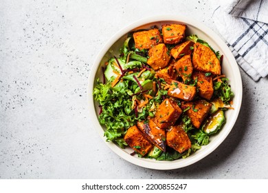 Baked Sweet Potato And Green Salad Bowl With Mustard Dressing, Top View. Vegan Food Concept.