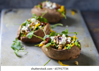 Baked Sweet Potato With Salad, Feta Cheese, Sundried Tomatoes, White Radish And Walnuts