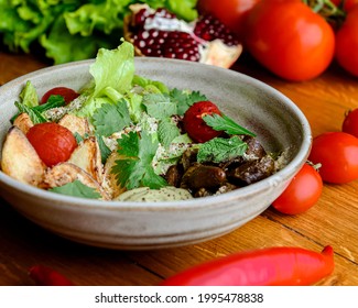 Baked sweet potato salad with tomatoes served in a bowl over rustic wooden table. Georgian cuisine concept. - Shutterstock ID 1995478838