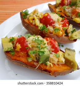 Baked Sweet Potato With Scrambled Egg, Avocado And Tomato Garnish With Parsley