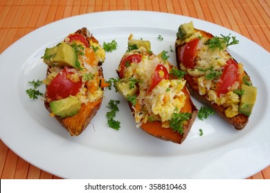 Baked Sweet Potato With Scrambled Egg, Avocado And Tomato Garnish With Parsley