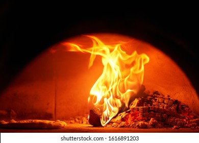 Baked Tasty Margherita Pizza In Traditional Wood Oven In Naples Restaurant, Italy. Original Neapolitan Pizza. Red Hot Coal.