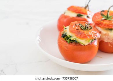 baked tomatoes stuffed with cheese and spinach  - healthy food style