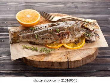 Baked trout fish with thyme and orange 