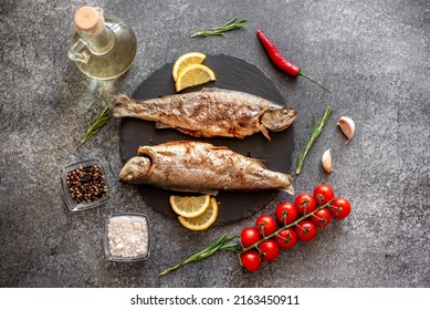 baked trout on a stone background