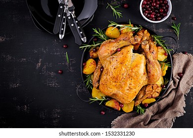 Baked turkey or chicken. The Christmas table is served with a turkey, decorated with bright tinsel. Fried chicken. Table setting. Christmas dinner. Top view - Shutterstock ID 1532331230