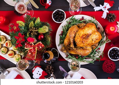 Baked Turkey. Christmas Dinner. The Christmas Table Is Served With A Turkey, Decorated With Bright Tinsel And Candles. Fried Chicken, Table.  Family Dinner. Top View