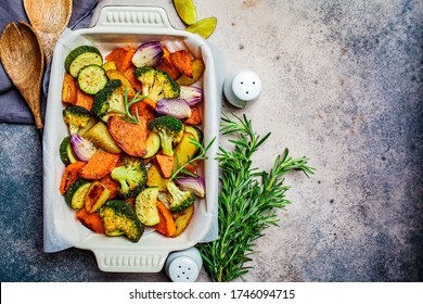 Baked Vegetables In The Oven Dish. Baked Sweet Potato, Zucchini And Broccoli. Healthy Vegan Food Concept.