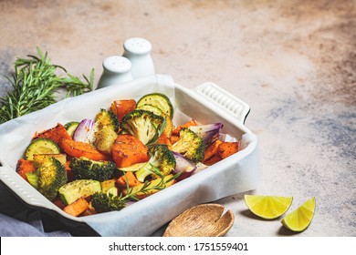 Baked Vegetables In The Oven Dish. Baked Sweet Potato, Zucchini And Broccoli. Healthy Vegan Food Concept.