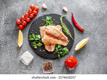 Baked White Fish Fillet Pangasius With Spices And Lemon On A Stone Background