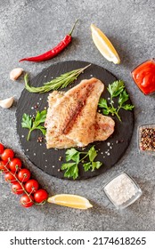 Baked White Fish Fillet Pangasius With Spices And Lemon On A Stone Background