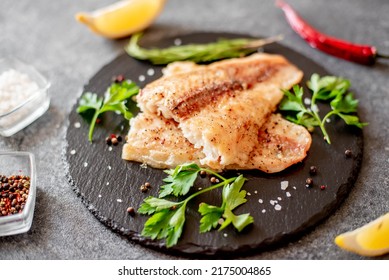 Baked White Fish Fillet Pangasius With Spices And Lemon On A Stone Background