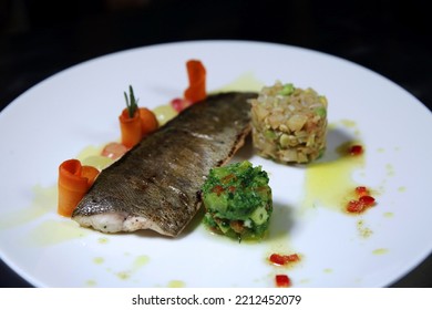 Baked Whole Fish With Vegetables On A White Plate. Top View