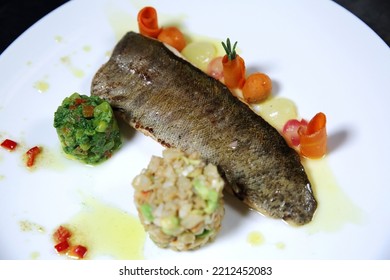 Baked Whole Fish With Vegetables On A White Plate. Top View