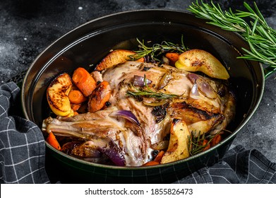 Baked Whole Lamb Shoulder Leg In A Baking Dish. Black Background. Top View