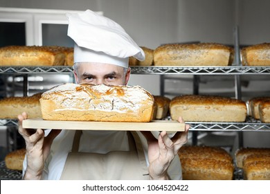 Baker In The Bakery.
Tasty Fresh Bread Straight From The Oven.
