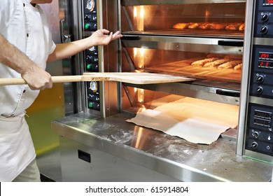 Baker Bakes Bread In The Oven