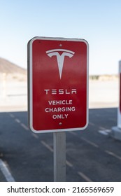 Baker, California, USA-October 12, 2021 - Tesla supercharging station during the day.