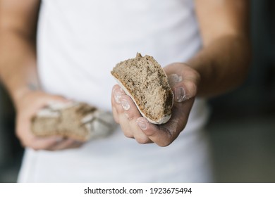 Baker or cooking chef holding fresh baked bread and breaking it in hands. Concept of cooking, successful businessman or start up. - Powered by Shutterstock