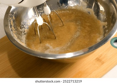Baker cooking mixing ingredients apple puree gelatin in metal bowl using electric mixer. Culinary cuisine baking food dish pastry. Preparing sweet marshmallows jelly apples homemade dessert.
