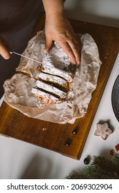 Baker Is Cutting Christmas Baked Goods, Stollen On A Wooden Board