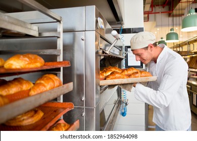 Baker enjoying the aroma of freshly baked breads - Powered by Shutterstock