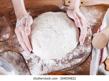 Baker Hands Making Sourdough Bread On A Wooden Table