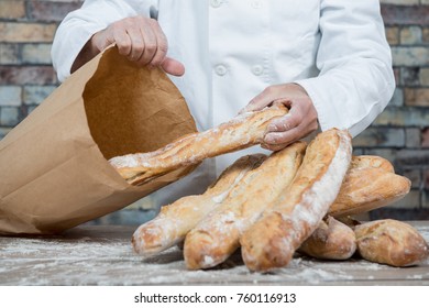 A Baker Holding Traditional Bread French Baguettes