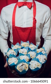 Baker keeps a tray with fresh bread man in red and white uniform baker holding a tray with bread making