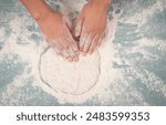 Baker kneading dough for pizza or artisan bread with his hands, prepare ingredients for food, baking pastry 