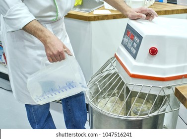 Baker Kneads Dough In An Industrial Dough Mixer