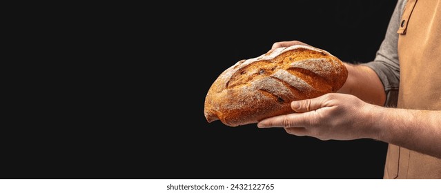 Baker man holding bread. loaf rye wheat bread. Long banner format. copy space for text. - Powered by Shutterstock