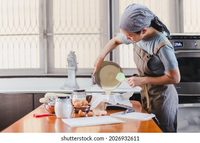 Baker Pouring Cake Mixture Into A Cake Tin With Paper  For Baking Cheesecake