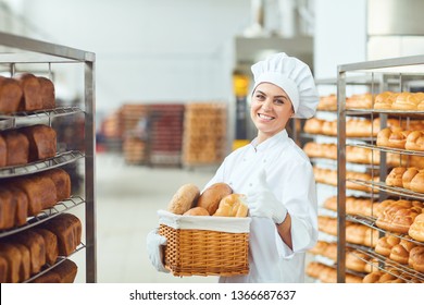 A baker woman holding a basket of baked in her hands at the bakery - Powered by Shutterstock