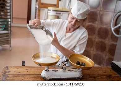 Baker Woman Putting Sugar On A Weighing Scales