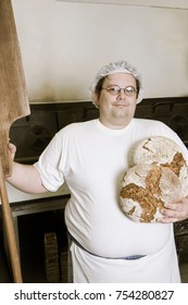 Bakerman Standing In Front Of An Oven