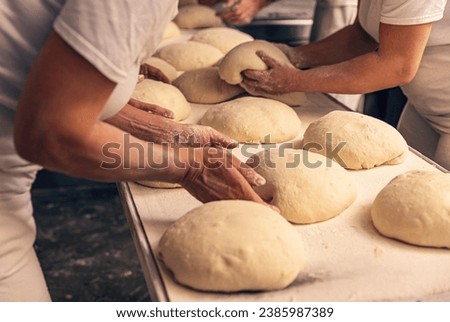 Bakers forming bread dough in a bakery. Bakery Concept.