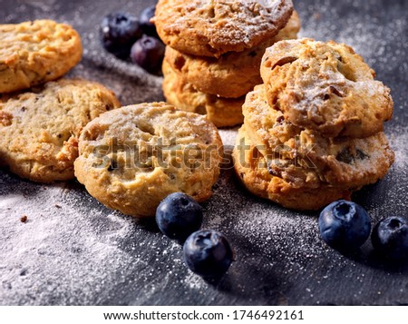 Bakers gonna bake. Serving food on slate. Oatmeal cookies biscuit with blueberry on dark tiles countrylike. Chocolate chip cookies shop on window display. Lunch in inexpensive cafe.